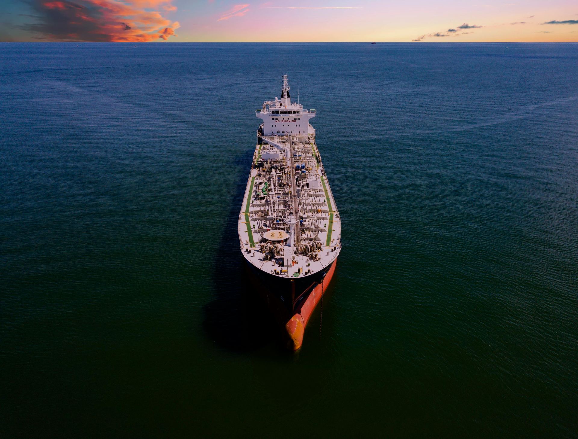 Container vessel sailing at sunset