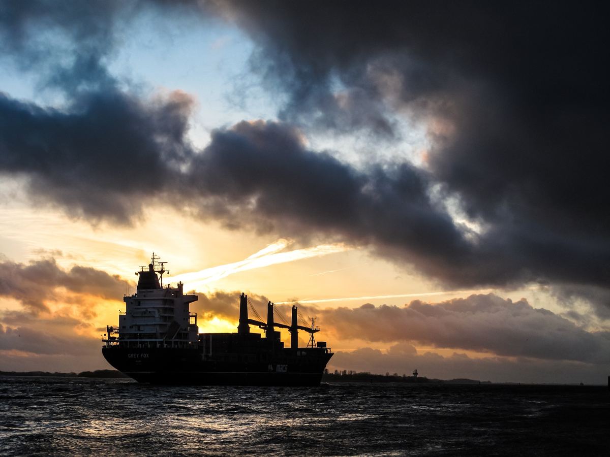 Cargo vessel silhouette at sunset